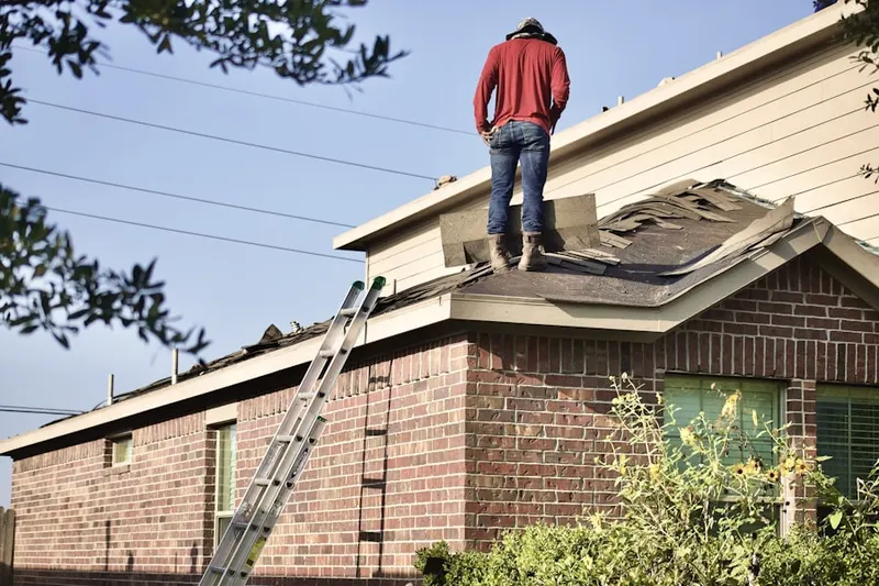 Professional roofer working on a residential roof in Morrisville Station